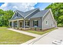 Gray farmhouse-style home with a front porch at Tbd 2 Cedar Lane Rd, Sanford, NC 27332