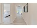 Bright hallway with light-grey flooring and view of bedroom and living area at 8027 Royal Dr, Sanford, NC 27332