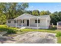 Front view of updated home showcasing a spacious yard at 712 Blount St, Smithfield, NC 27577