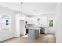 Spacious kitchen with white cabinets, granite countertops, and a gray island at 1120 N Fayetteville Ave, Dunn, NC 28334