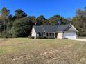 One story house with a two car garage and large yard at 151 Goose Creek Cir, Dunn, NC 28334