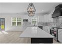 Modern kitchen with white cabinets, quartz countertops, and a large island at 123 Persimmon Tree Dr, Cameron, NC 28326