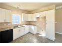 Modern kitchen featuring white cabinets, granite countertops, and black appliances at 15 Red Bird Dr, Cameron, NC 28326