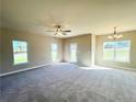 Spacious living room with neutral carpet, large windows, and ceiling fan at 15 Red Bird Dr, Cameron, NC 28326