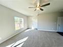 Bright living room featuring a ceiling fan and large windows at 29 Red Bird Dr, Cameron, NC 28376