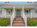 Brick steps leading to a covered porch with white railings at 1003 Kelly Dr, Nashville, NC 27856