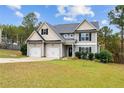 Two-story house with a three-car garage and landscaped yard at 58 Shortleaf Ct, Cameron, NC 28326