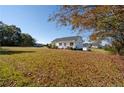 White house with large yard and trees, seen from the side at 732 N Pleasant Coats Rd, Benson, NC 27504