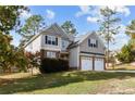 Two story house with a three car garage and manicured lawn at 20 Lakeforest Trl, Sanford, NC 27332