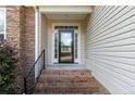 Brick steps leading to a glass front door with sidelights at 20 Lakeforest Trl, Sanford, NC 27332