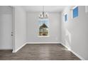 Bright dining room with hardwood floors and a chandelier at 11 Decoy Spread Pl, Lillington, NC 27546