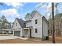 Modern farmhouse style home with gray siding and a two-car garage at 322 Quail Hollow, Sanford, NC 27332