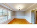 Formal dining room with hardwood floors, wainscoting, and a chandelier at 56 Briarwood Pl, Sanford, NC 27332