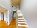 Bright entryway with hardwood floors and a staircase leading to the upper level at 56 Briarwood Pl, Sanford, NC 27332