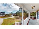 Covered porch with white columns, offering views of a residential street at 56 Briarwood Pl, Sanford, NC 27332