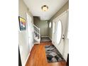 Bright entryway with hardwood floors and staircase leading upstairs at 185 Swain St, Spring Lake, NC 28390