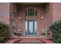 Brick porch with two rocking chairs and a blue door at 807 Merry St, Dunn, NC 28334