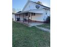 House exterior showcasing a covered patio and grassy backyard at 401 S 17Th St, Erwin, NC 28339