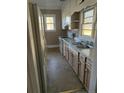 Bright kitchen featuring wood cabinets, tile flooring and stainless steel appliances at 401 S 17Th St, Erwin, NC 28339