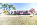 Brick ranch house with a landscaped lawn and walkway at 153 St Andrews Church Rd, Sanford, NC 27332