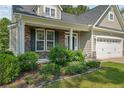 House exterior featuring a front porch with stone accents and landscaping at 128 Valley Stream Rd, Spring Lake, NC 28390