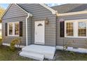 Gray house with white front door, shutters, and steps at 900 N Orange Ave, Dunn, NC 28334