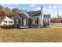 Gray house with white trim, landscaping, and a spacious lawn at 900 N Orange Ave, Dunn, NC 28334