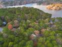 An aerial view of a house nestled in a wooded area near a lake at 1374 Pennsylvania Ave, Sanford, NC 27332