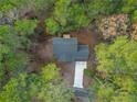 Aerial view showcasing a house nestled among lush green trees at 1374 Pennsylvania Ave, Sanford, NC 27332
