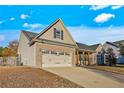 Front view of a tan brick ranch home with a two-car garage at 234 Lockwood Dr, Cameron, NC 28326