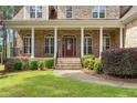 Brick front porch with a red door and white columns at 250 The Inner Cir, Spring Lake, NC 28390