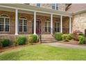 Brick front porch with a red door and white columns at 250 The Inner Cir, Spring Lake, NC 28390
