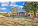 Brick ranch house with a large front yard and mature trees at 81 Sandclay Dr, Spring Lake, NC 28390