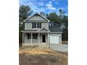 New gray house with a gray roof, white garage door and black front door at 826 Roberts Rd, Sanford, NC 27332