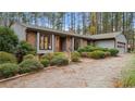 Ranch style home with mature trees and a gravel driveway at 1982 Wedgewood Dr, Sanford, NC 27332