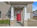 Red front door with glass panel, stone accents flanking white columns and covered entry at 73 Loyalist Rd, Cameron, NC 28326