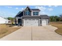 Attractive two-story residence featuring a three-car garage and a welcoming driveway at 22 Laramie Ln, Selma, NC 27576