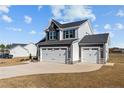 Modern two-story home with a three-car garage and large front yard at 22 Laramie Ln, Selma, NC 27576