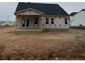 Back of house showing covered patio and yard at 203 Rocking Canal Pl, Erwin, NC 28339