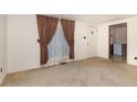 Bright living room with large window and door at 74 Willett Rd, Sanford, NC 27332