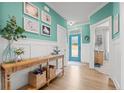 Bright entryway with teal walls, wood console table, and view to living area at 113 Education Dr, Spring Lake, NC 28390