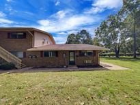 Brick ranch-style home with a spacious lawn and mature trees at 130 S Estes Dr # B7, Chapel Hill, NC 27514