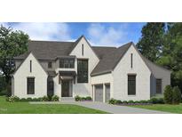 Two-story home with white brick exterior, gray accents, and a three-car garage at 1805 Okeefe Ln # 1D, Raleigh, NC 27613