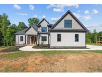 Modern farmhouse exterior with gray siding at 4268 Jacks Creek Trl, Burlington, NC 27215