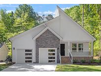 Modern two-story house with stone accents and two-car garage at 104 Cochise Dr, Louisburg, NC 27549