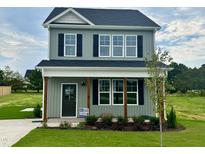 Two-story house with gray siding, white trim, and a front porch at 40 Longbow Dr, Middlesex, NC 27557
