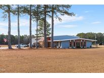 Blue metal building with ample parking and landscaping at 124 Don Ron Rd, Erwin, NC 28339
