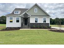 Charming two-story home with stone accents and a welcoming front porch at 73 Sage Ln # 008, Four Oaks, NC 27524