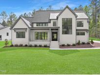 Two-story modern farmhouse with gray roof and white exterior at 7957 Wexford Waters Ln, Wake Forest, NC 27587