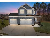 Two-story home with gray siding, white trim, and a two-car garage at 345 Sutherland Dr, Franklinton, NC 27525